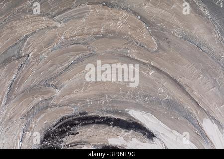 Detail of an abstract painting showing layered acrylic and oil brush strokes in muted grey, taupe and cream tones with visible palette knife texture. Stock Photo