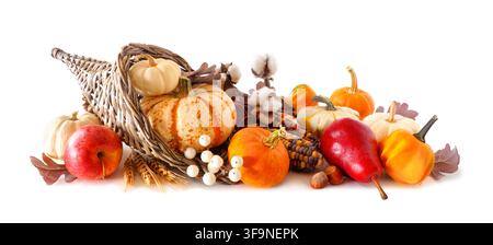 Thanksgiving harvest cornucopia filled with autumn fruits and vegetables. Side view isolated on a white background. Stock Photo