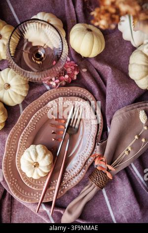 Elegant autumn table with pumpkins, glassware, and vintage accents Stock Photo