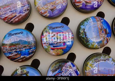 Close up view of colourful round fridge magnets with Marmaris text inscription on display at a souvenir shop in Mugla province, Turkey. Stock Photo