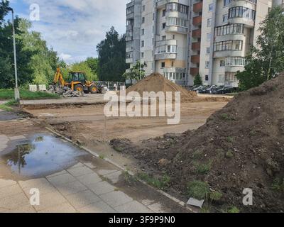 Large piles of excavated soil at a construction site with rough dirt ...