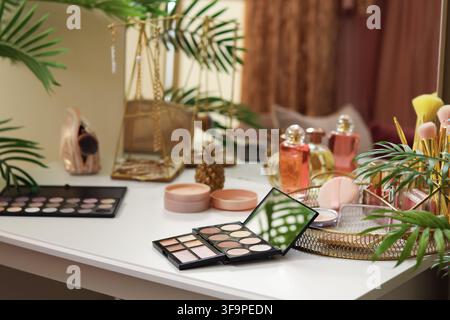 Makeup products on table in dressing room, closeup Stock Photo