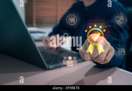 Businessman managing ISO certification and quality management system with compliance dashboard, quality assurance, internal audit, operational excelle Stock Photo