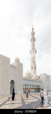 People walking outside Sheikh Zayed Grand Mosque in Abu Dhabi, United Arab Emirates, with copy space Stock Photo
