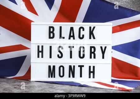 BLACK HISTORY MONTH patriotic scene with signboard and waving flag message UNITED KINGDOM with national colors Festive background with British flag an Stock Photo
