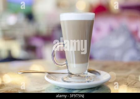 Cafe latte in a glass cup at the cafe. Stock Photo