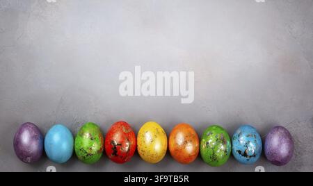 Easter concept wit colorful Easter eggs on grey background. Top view with copy space Stock Photo
