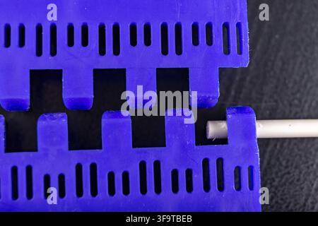 Plastic modular belt. Accessories for the food industry. Dark background Stock Photo