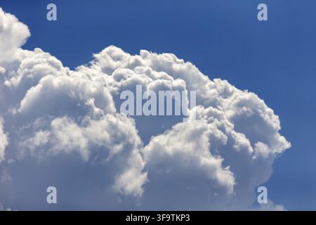 Blue sky with puffy cloud formation in a shape of a heart, natural background Stock Photo