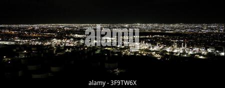 Aerial panoramic night view of glowing city lights and urban landscape Stock Photo