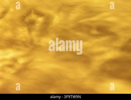 Golden amber glass texture macro with wavy translucent surface for warm abstract background Stock Photo