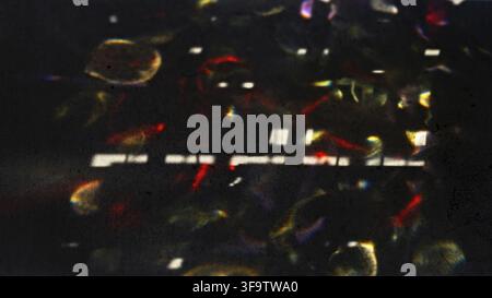 Abstract Light Refractions on Dark Surface Creating Colorful Patterns Stock Photo
