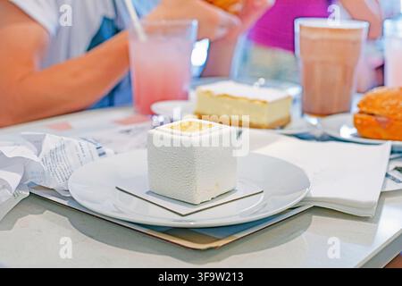 Portioned French dessert entremet, a cube-shaped mousse pastry Stock Photo