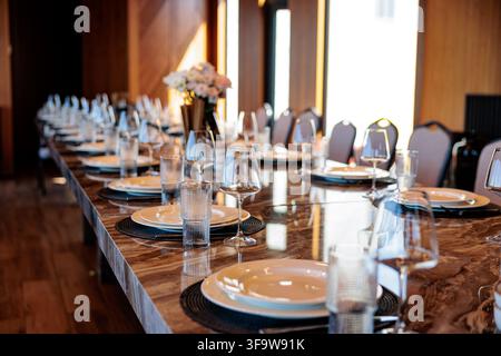 Beautifully Set Dining Table Ready for an Elegant Dinner Event at a Riverside Venue in Spring Stock Photo