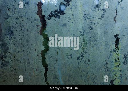 A blue patina texture, weathered metal surface, abstract background with mottled corrosion, dark cracks, and green oxidation creating distressed indus Stock Photo