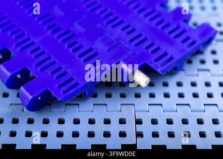 Plastic modular belt. Accessories for the food industry. Dark background Stock Photo