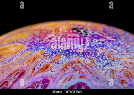 Multicolored abstract chaotic pattern inside of the soap bubble, closeup. Stock Photo