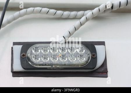 An industrial light fixture white cable closeup Stock Photo