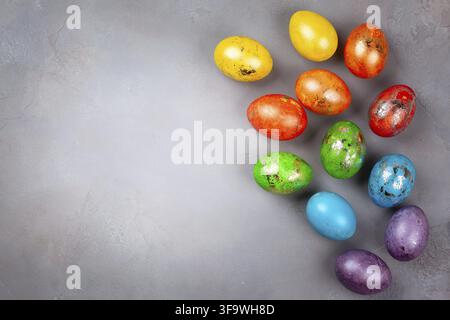 Easter concept wit colorful Easter eggs on grey background. Top view with copy space Stock Photo