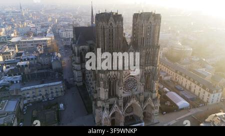 Aerial view of Cathedral in Reims, France 01.02.2025 during morning light. The intricate Gothic facade and rose window stand out against the historic Stock Photo