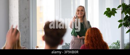 Group of college students attending lecture in university hall. Stock Photo