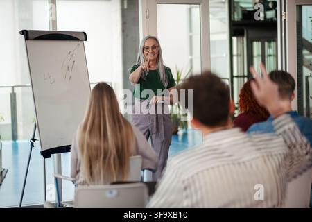 Group of college students attending lecture in university hall. Stock Photo