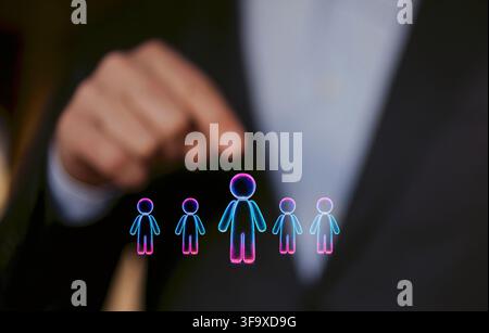 Business professional gestures towards digital figures symbolizing individuals, illustrating concepts of growth and development in a corporate environ Stock Photo