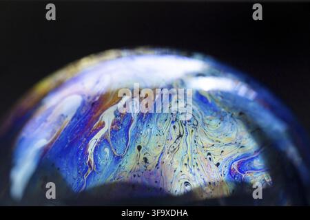 Abstract pattern, multicolored chaotic texture inside of the soap bubble, closeup. High quality FullHD footage Stock Photo