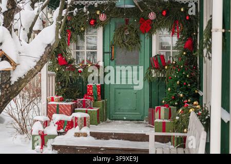 House porch decorated for Christmas in the snow Stock Photo