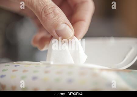 Hand picked a wet wipes in package box, Wet wipes in a woman's hand Stock Photo
