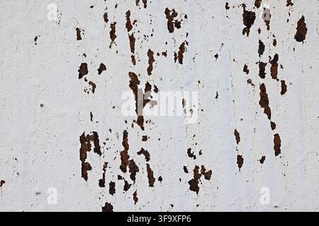 Weathered Rusted Metal Surface with White Peeling Paint Texture Stock Photo