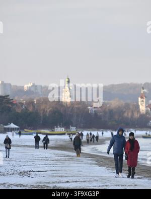 people-seen-walking-along-the-beach-towards-a-safe-zone-during-the