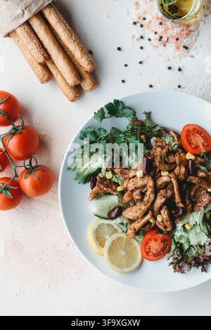 Grilled chicken salad with breadsticks and fresh vegetables Stock Photo