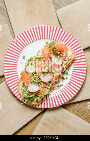 Smoked salmon toast with radish and fresh greens Stock Photo