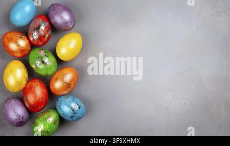 Easter concept wit colorful Easter eggs on grey background. Top view with copy space Stock Photo