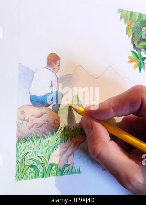 Man's hand painting a landscape with color pencils. Close view. Stock Photo