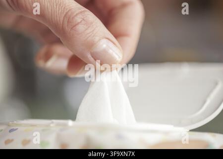 Hand picked a wet wipes in package box, Wet wipes in a woman's hand Stock Photo