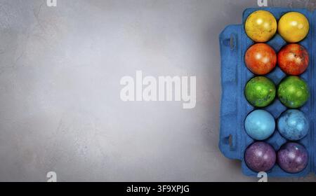 Easter concept wit colorful Easter eggs on grey background. Top view with copy space Stock Photo