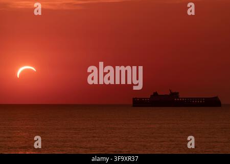 A ferry sails near the port of Livorno, Italy, during the solar eclipse of August 12, 2026 Stock Photo