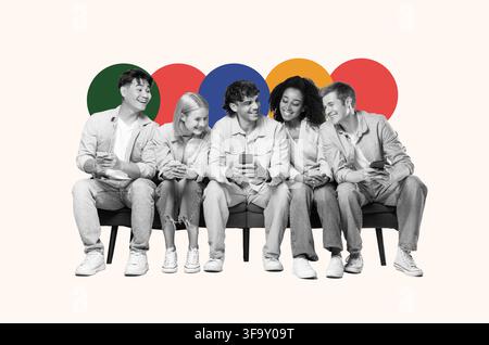 Diverse Group Of Young People Smiling While Checking Smartphones Together, Socializing Stock Photo