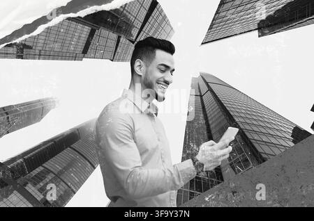 Smiling Young Middle Eastern Man Using Smartphone In Urban Setting, Business Concept Stock Photo
