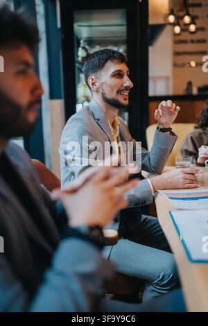 Business professionals discussing ideas over coffee during a casual meeting at a modern cafe Stock Photo