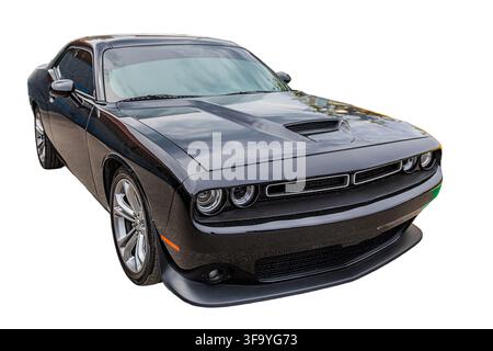 Sleek two-door sports car, three-quarter angle profile, front and side view, dark color, large multi-spoke wheels, modern design, clean professional c Stock Photo