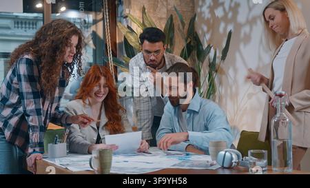 Casual informal business team five people men women working with documents data marketing result discuss in office startup conference brainstorming Stock Photo