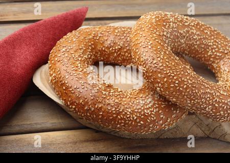 Freshly Baked Sesame Simit Bread Rings and Red Napkin on Wooden Table Stock Photo