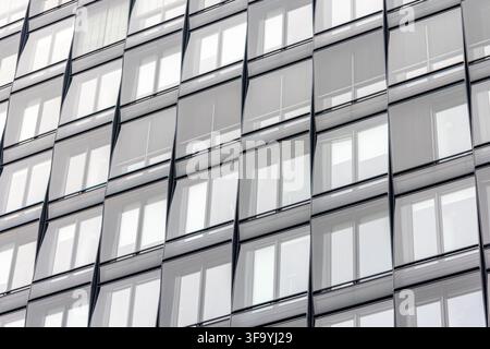 Modern glass facade with blinds. Repeating windows for design content. Stock Photo