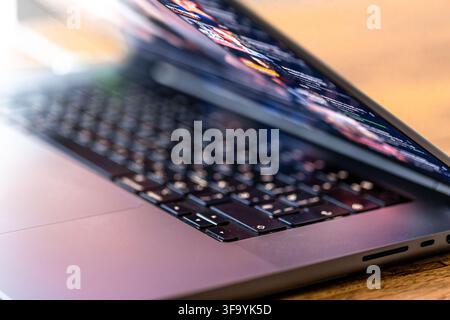 Laptop keyboard and blurred digital screen. Technology workspace closeup. Stock Photo