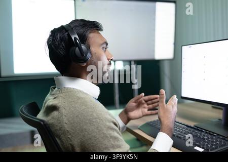 ndian Call Center Worker Talking With Headset At Computer Stock Photo