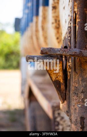 Close-up side view of a cracked dump truck tailgate lock with the focus on the foreground Stock Photo