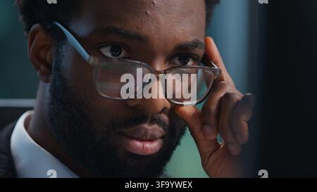 Close up African American business man in glasses looking at computer monitor working businessman male guy professional executive agent wearing Stock Photo